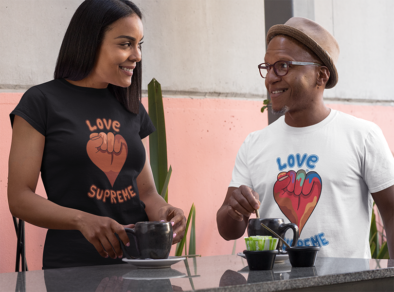 Smiling Couple drinking coffee wearing Love Supreme t-shirts